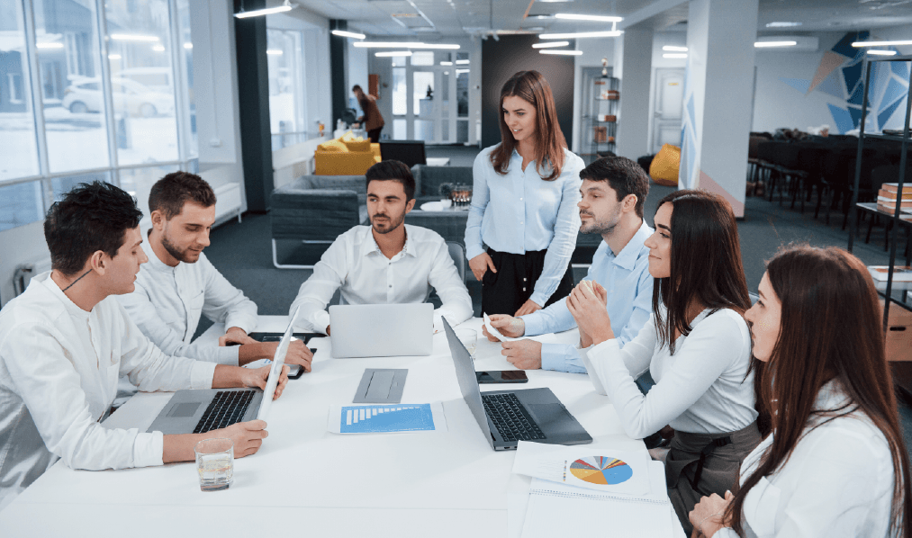 Modern office setting with financial charts and a handshake, symbolizing investor relations and growth